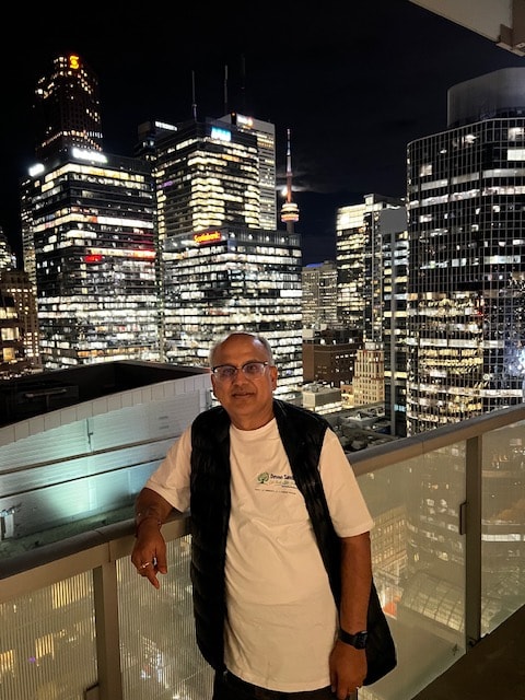 Deven in his campaign shirt — Toronto skyline at night