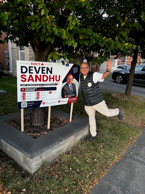 Deven celebrating a lawn sign placement with a Vaughan resident
