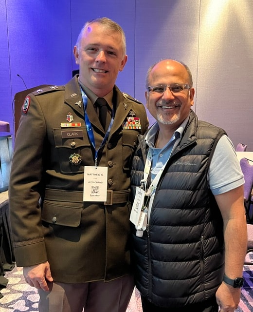 Deven with a military officer at a leadership conference