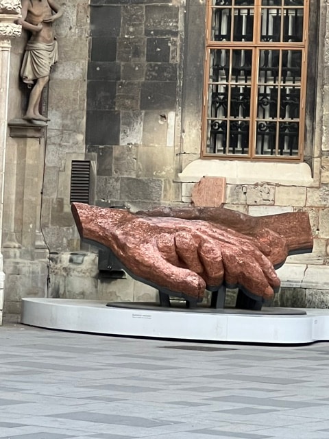 Large bronze hand sculpture — public art in the community